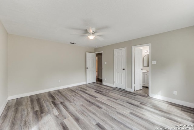 1703 Allende, San Antonio, TX 78237 - unfurnished bedroom featuring visible vents, a closet, wood finished floors, baseboards, and ensuite bath