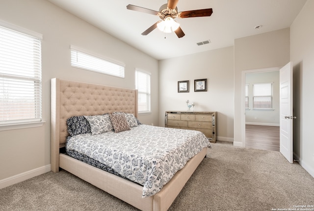 bedroom with multiple windows, carpet flooring, and ceiling fan