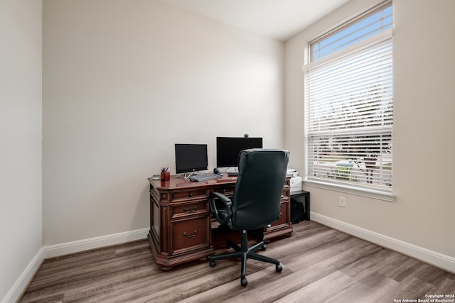 office with light wood-type flooring