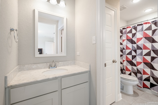 bathroom with vanity, toilet, and tile patterned floors