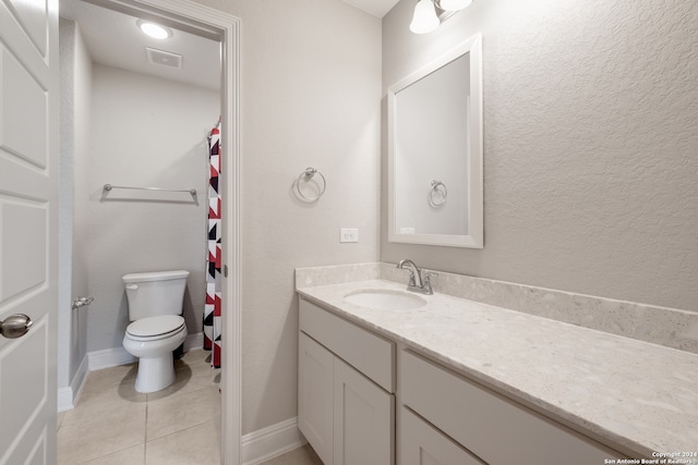 bathroom with vanity, toilet, and tile patterned floors