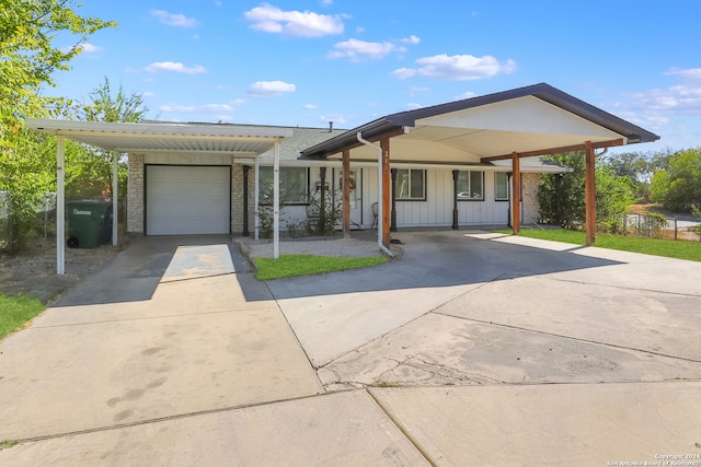 single story home featuring a carport and a garage