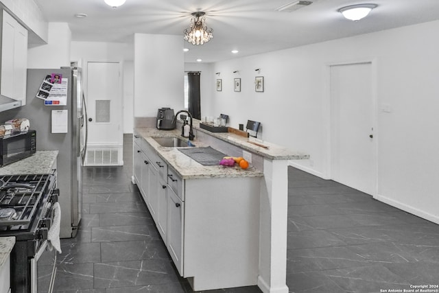 kitchen featuring kitchen peninsula, white cabinets, a kitchen breakfast bar, stainless steel appliances, and sink