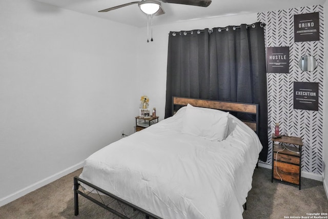 bedroom with ceiling fan and dark colored carpet