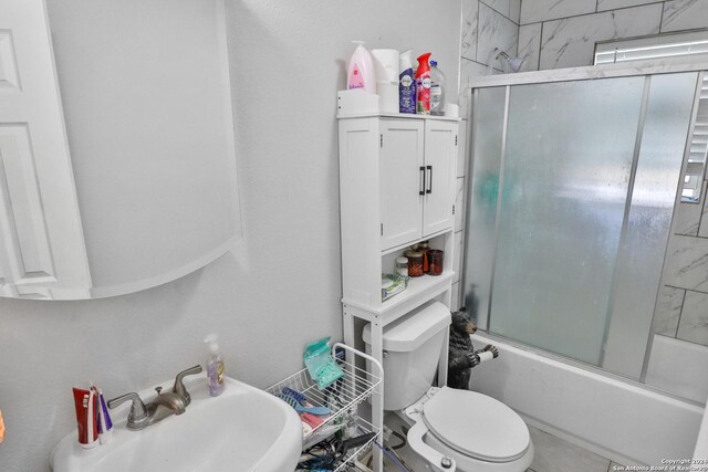 14024 Wisdom Rd, Atascosa, TX 78002 - full bath featuring bath / shower combo with glass door, toilet, and a sink
