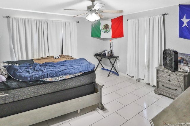 tiled bedroom with ceiling fan