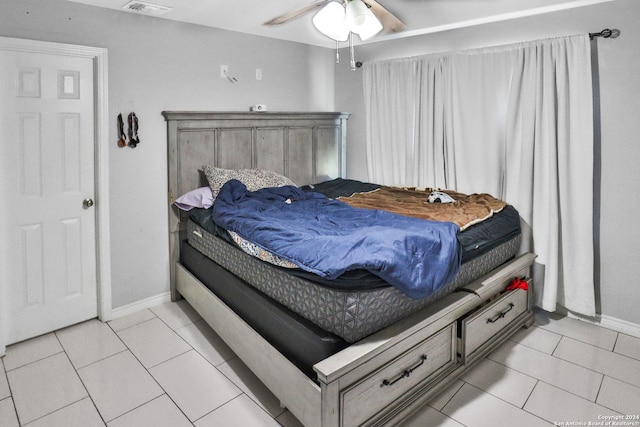 bedroom featuring light tile patterned floors and ceiling fan