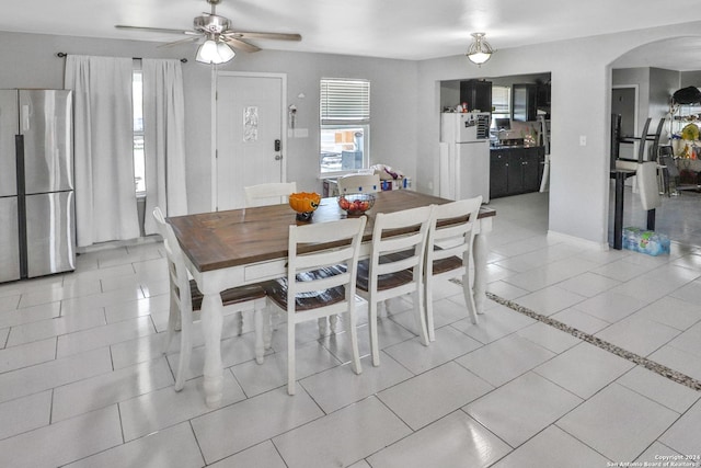 14024 Wisdom Rd, Atascosa, TX 78002 - dining space with light tile patterned flooring, arched walkways, and a ceiling fan
