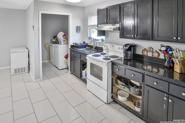 kitchen with washer / dryer, electric range, light tile patterned flooring, refrigerator, and sink