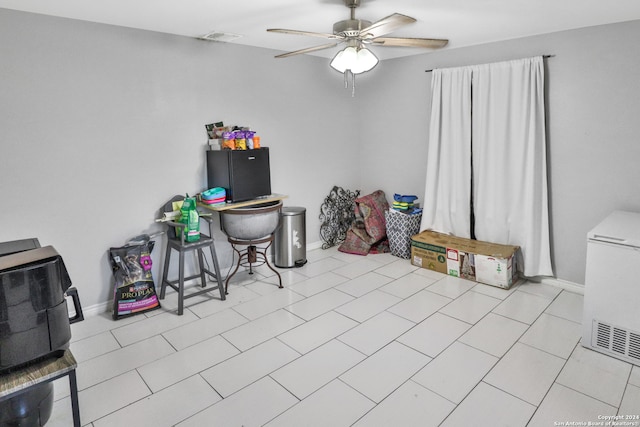 misc room with light tile patterned flooring and ceiling fan