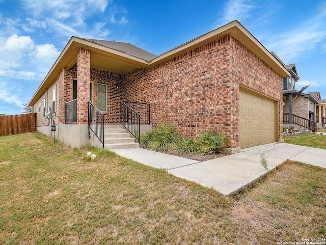 view of front of house with a garage and a front lawn