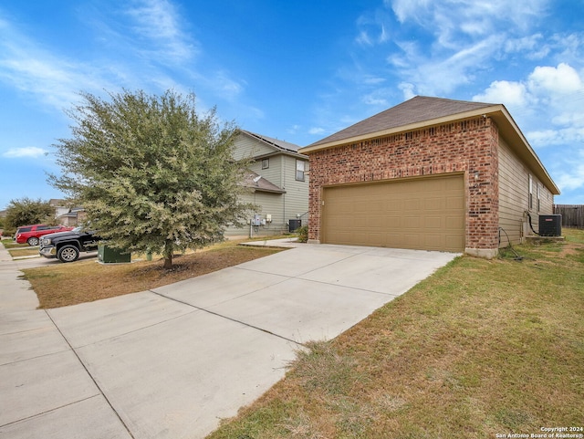 view of front of house featuring cooling unit, a front lawn, and a garage