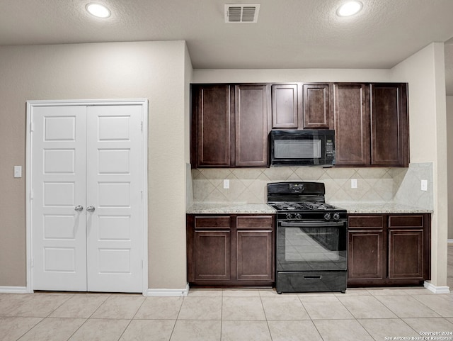 kitchen with dark brown cabinetry, black appliances, and backsplash