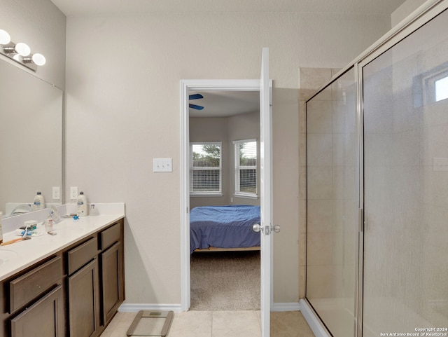 bathroom with vanity, tile patterned floors, and a shower with door