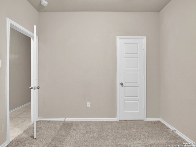 spare room featuring light colored carpet