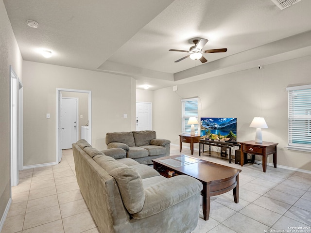 tiled living room featuring a textured ceiling and ceiling fan