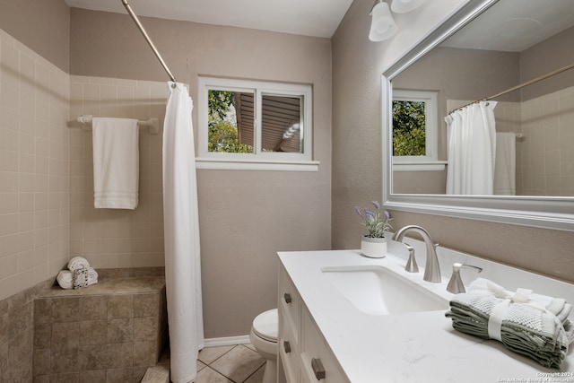 bathroom with vanity, toilet, walk in shower, and tile patterned flooring