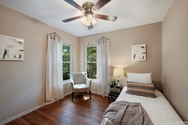 bedroom with dark wood-type flooring and ceiling fan