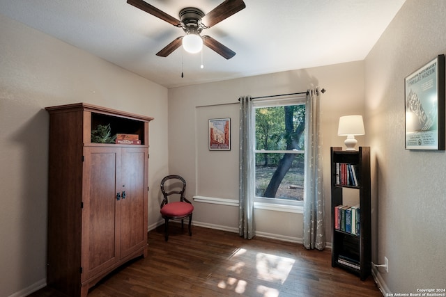 sitting room with dark hardwood / wood-style floors and ceiling fan