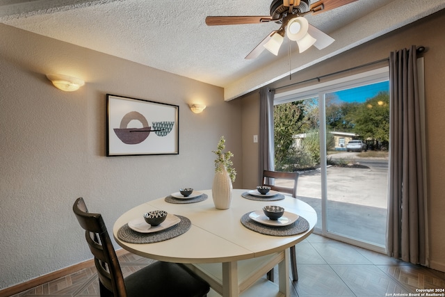 dining room with a textured ceiling and ceiling fan