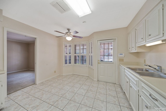 kitchen with white cabinets, ceiling fan, dishwasher, light tile patterned flooring, and sink