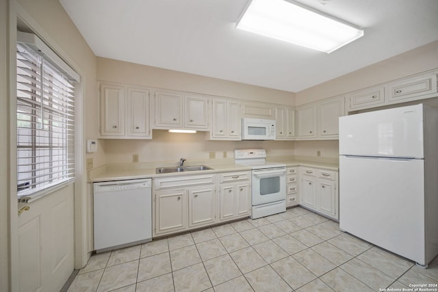 kitchen with white cabinets, sink, light tile patterned floors, and white appliances