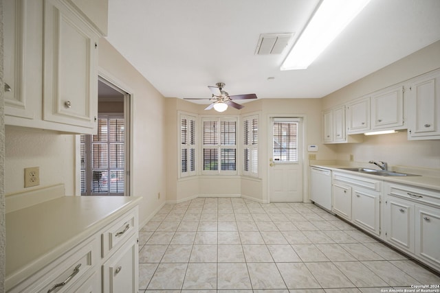 kitchen featuring dishwasher, sink, white cabinetry, ceiling fan, and light tile patterned floors