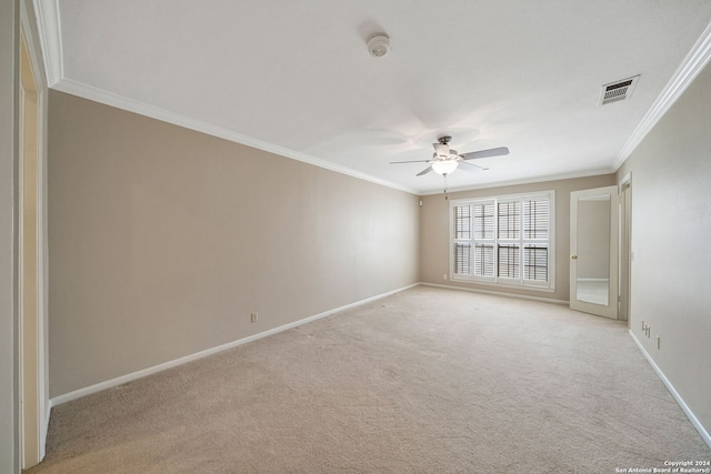 spare room with light carpet, crown molding, and ceiling fan