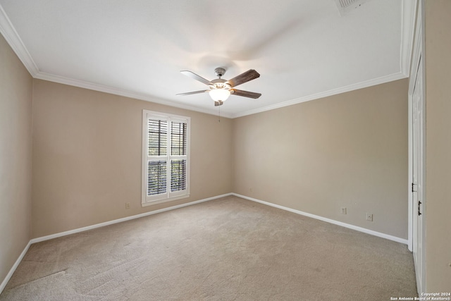 unfurnished room featuring crown molding, light colored carpet, and ceiling fan