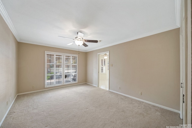 carpeted spare room with ornamental molding and ceiling fan