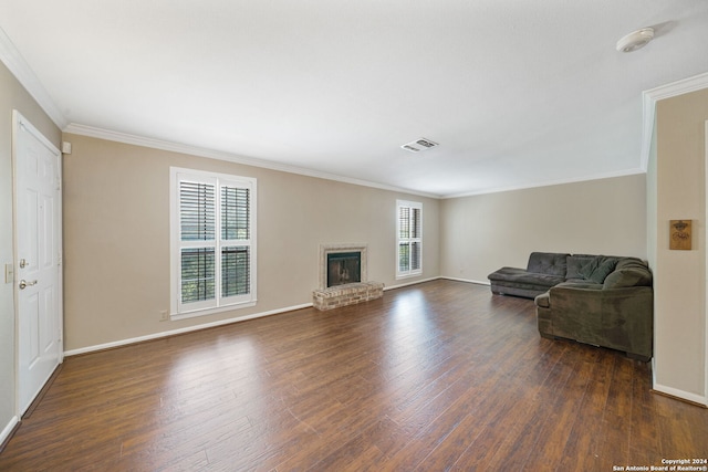 living room featuring crown molding, a fireplace, and dark hardwood / wood-style floors