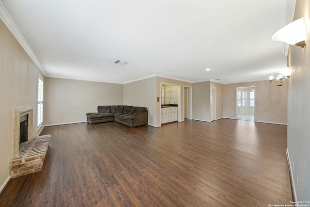 unfurnished living room with crown molding, dark hardwood / wood-style floors, and a brick fireplace