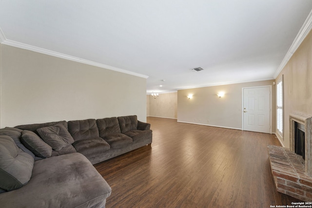 living room featuring a brick fireplace, ornamental molding, and dark hardwood / wood-style flooring