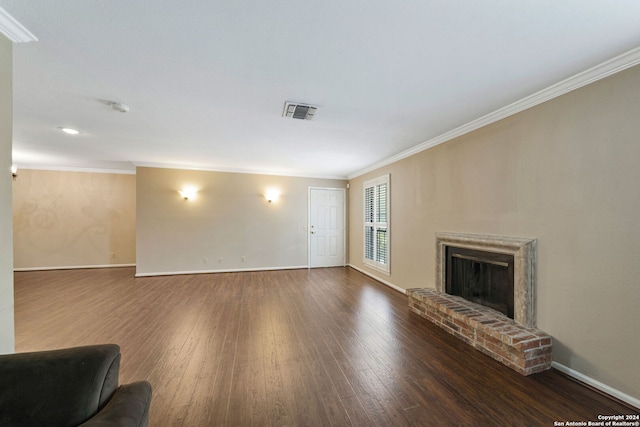 living room with ornamental molding, a brick fireplace, and dark hardwood / wood-style floors