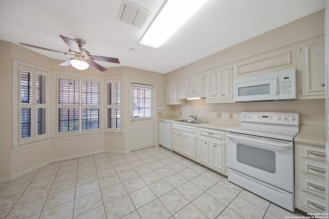 kitchen featuring white appliances, sink, ceiling fan, white cabinets, and light tile patterned floors