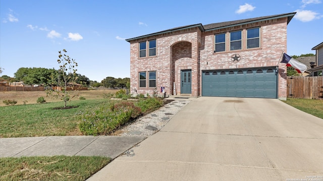 view of front of house featuring a front yard and a garage