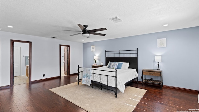 bedroom featuring ceiling fan, a textured ceiling, and dark hardwood / wood-style flooring