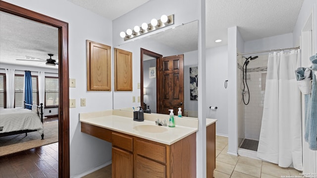 bathroom with vanity, a textured ceiling, a shower with shower curtain, and wood-type flooring