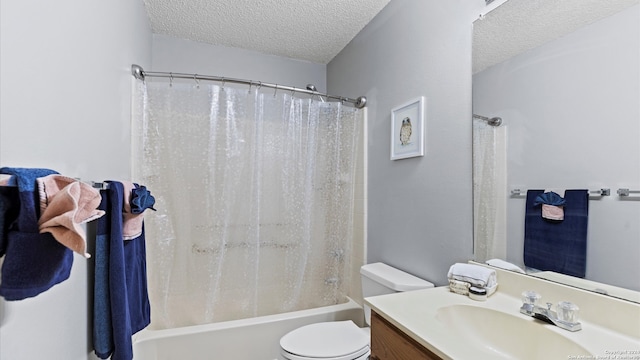 full bathroom featuring toilet, a textured ceiling, shower / tub combo with curtain, and vanity