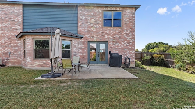 back of property featuring a patio and a lawn