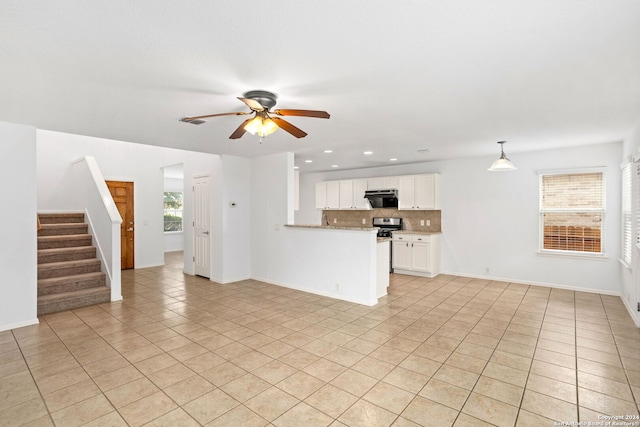 unfurnished living room featuring ceiling fan and light tile patterned floors