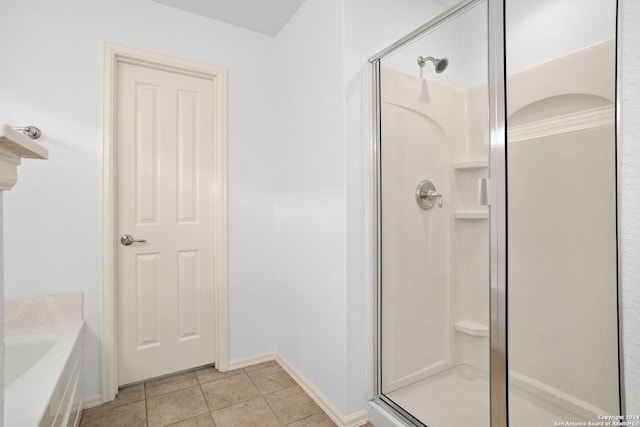 bathroom featuring tile patterned floors, crown molding, and shower with separate bathtub