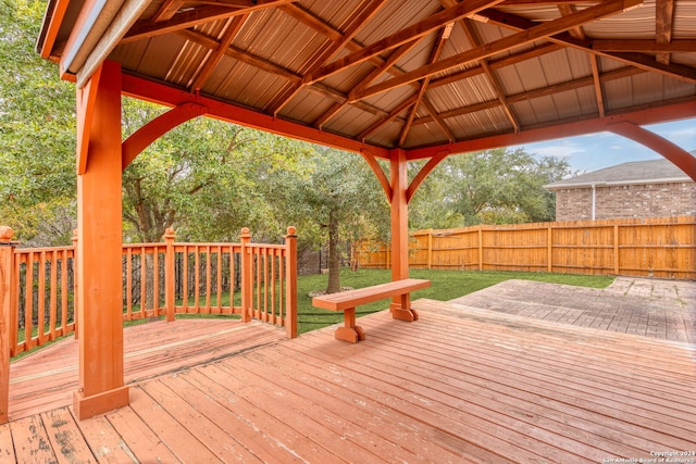 deck featuring a gazebo and a yard