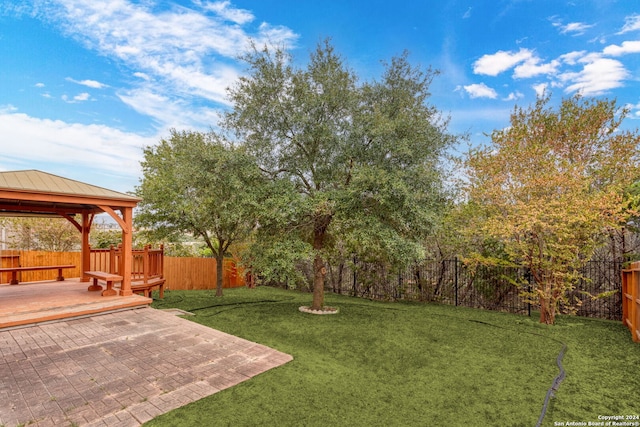 view of yard with a patio area, a gazebo, and a wooden deck