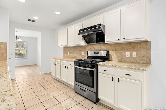 kitchen featuring stainless steel gas range oven, exhaust hood, white cabinetry, light stone countertops, and light tile patterned flooring