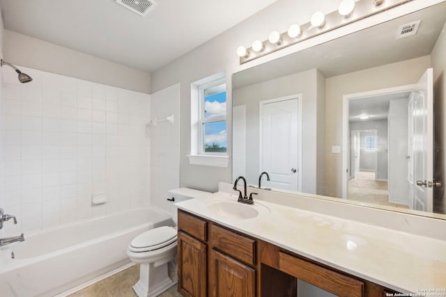 full bathroom with toilet, tile patterned floors, vanity, and tiled shower / bath combo