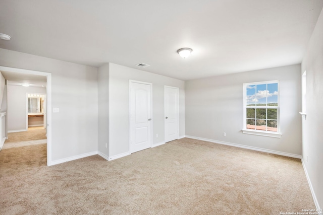 unfurnished bedroom featuring light carpet