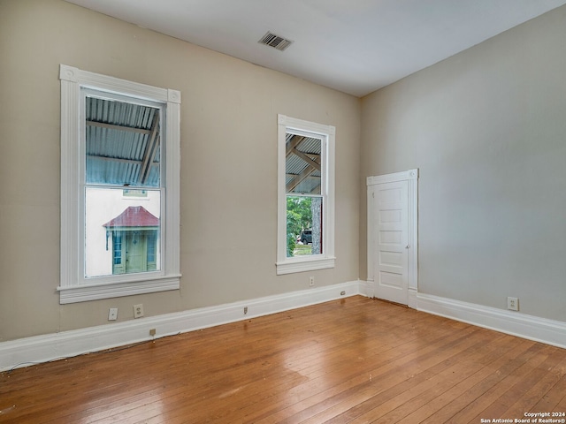 empty room with hardwood / wood-style floors