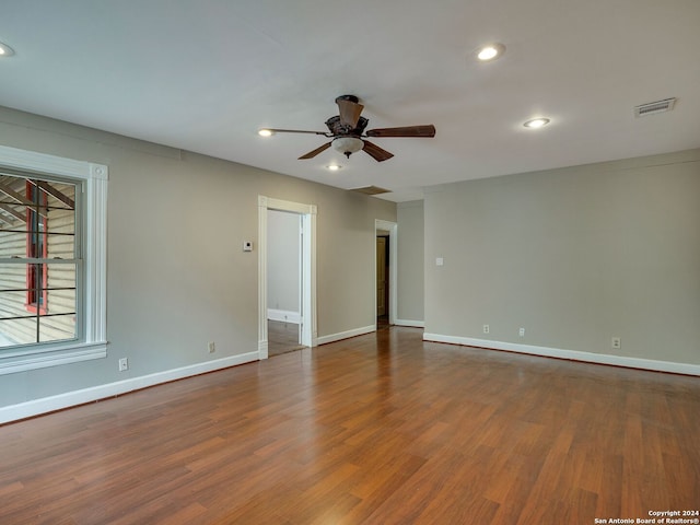 unfurnished room with ceiling fan and wood-type flooring