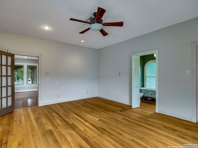 spare room with french doors, light wood-type flooring, and ceiling fan